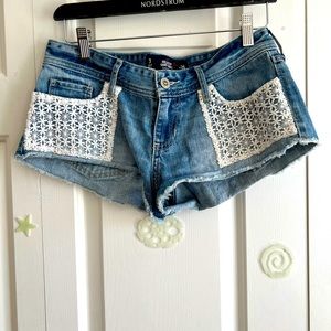 Hollister denim mini shorts with crochet design.